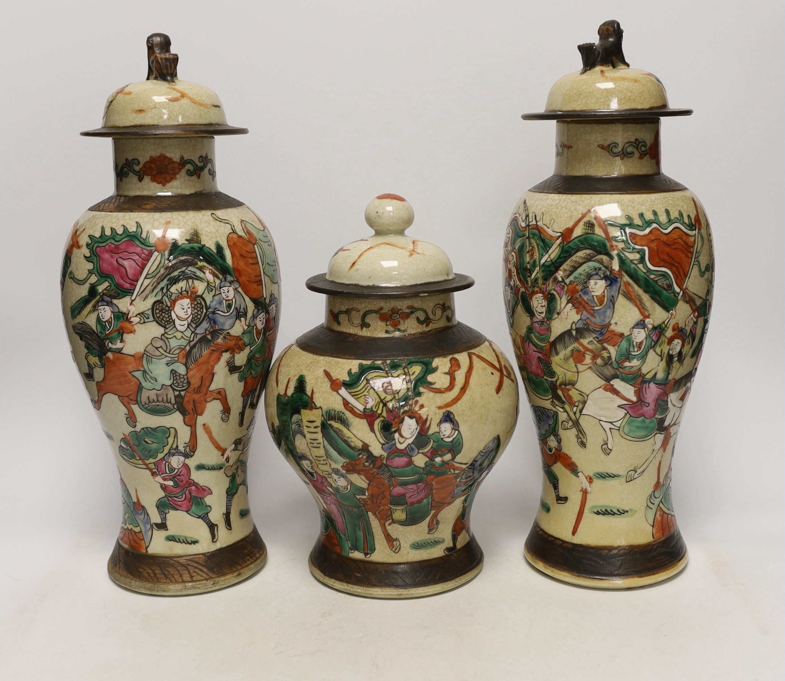 Three various Chinese crackleware famille rose jars and covers including a baluster example, largest 35cm high